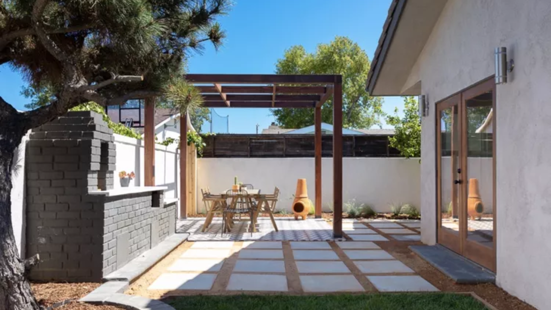 25 Beautiful Pergola Ideas to Add Style, Shade & Comfort to Your Backyard 7 Dark Wood Pergola for a Defined Outdoor Dining Space with Warmth and Style