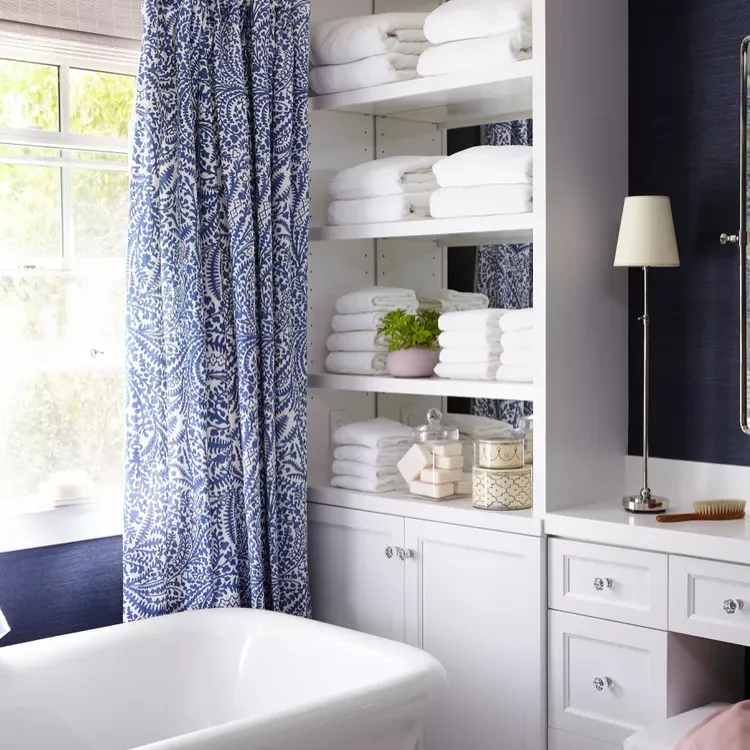 23Bathroom Shelf Ideas to Organize and Elevate Your Space 11 Hide the Hamper for a Cleaner Look