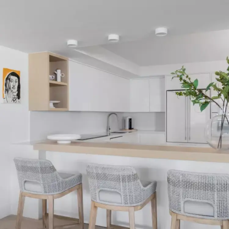 Modern kitchen decor with quartz backsplash and brass pendant lighting